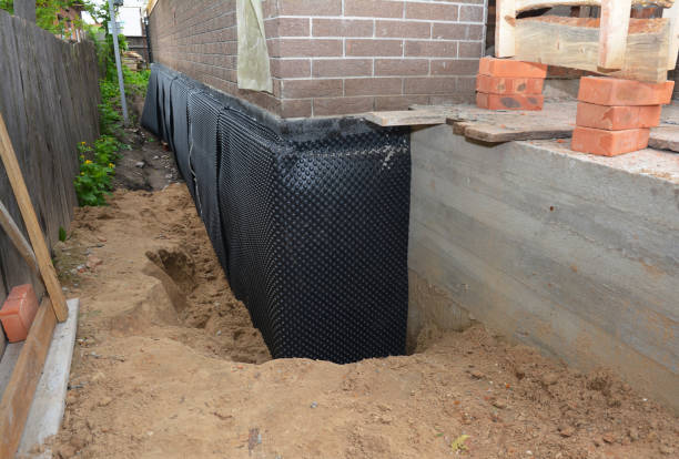 Happy homeowners after waterproofing job in Lansing